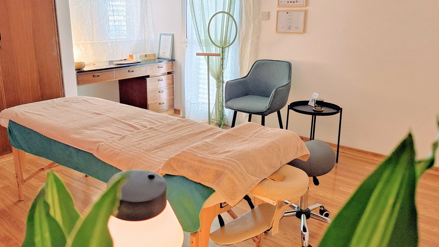 INTUNE - Soft light massage table with beige towels prepared for a Lymphatic Massage Client in Nicosia, Cyprus.